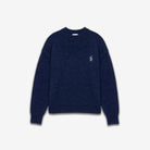Navy blue sweater with a small white logo on a light gray background